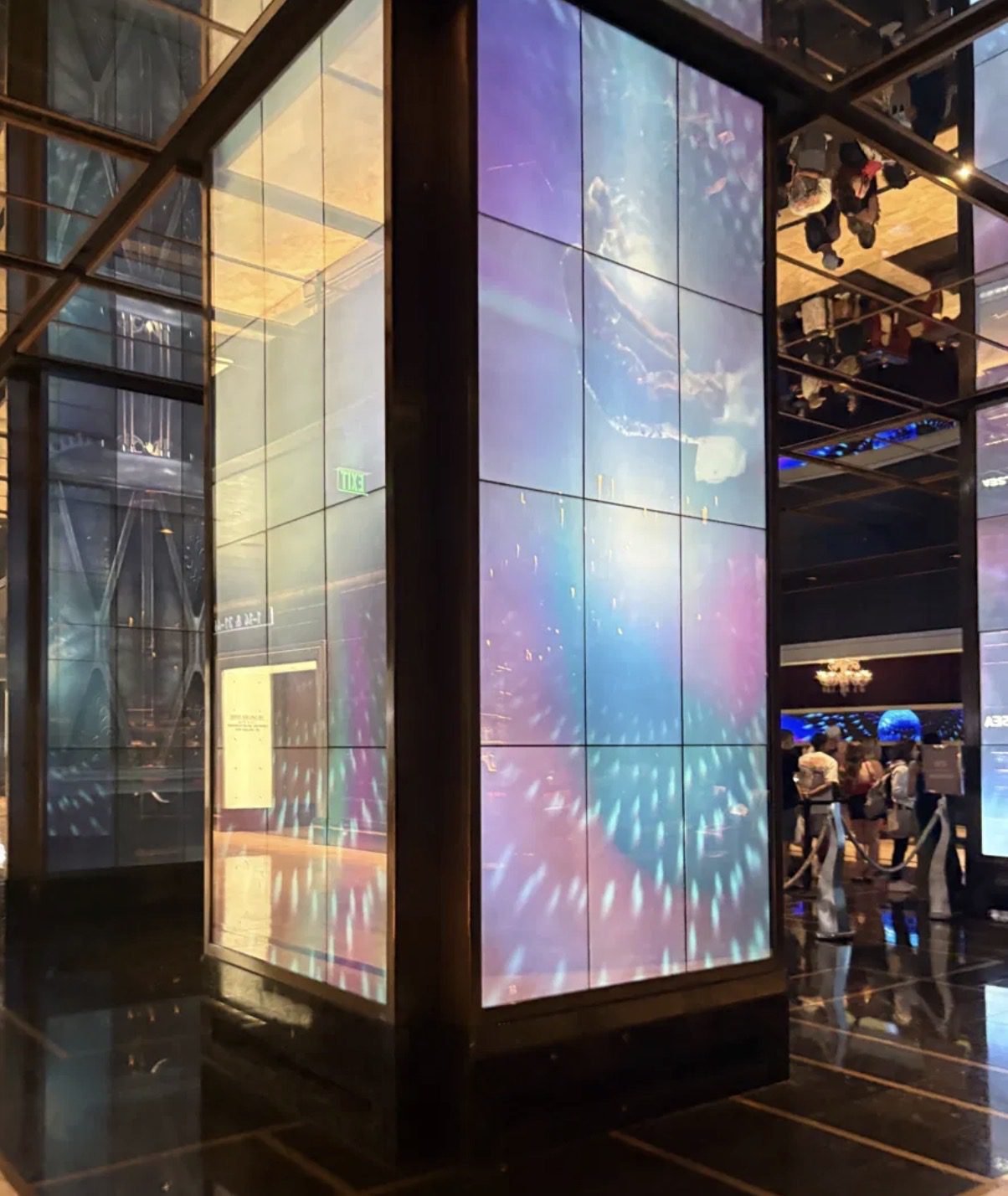 Mirrored elevator lobby at The Cosmopolitan Las Vegas featuring a colorful digital video wall