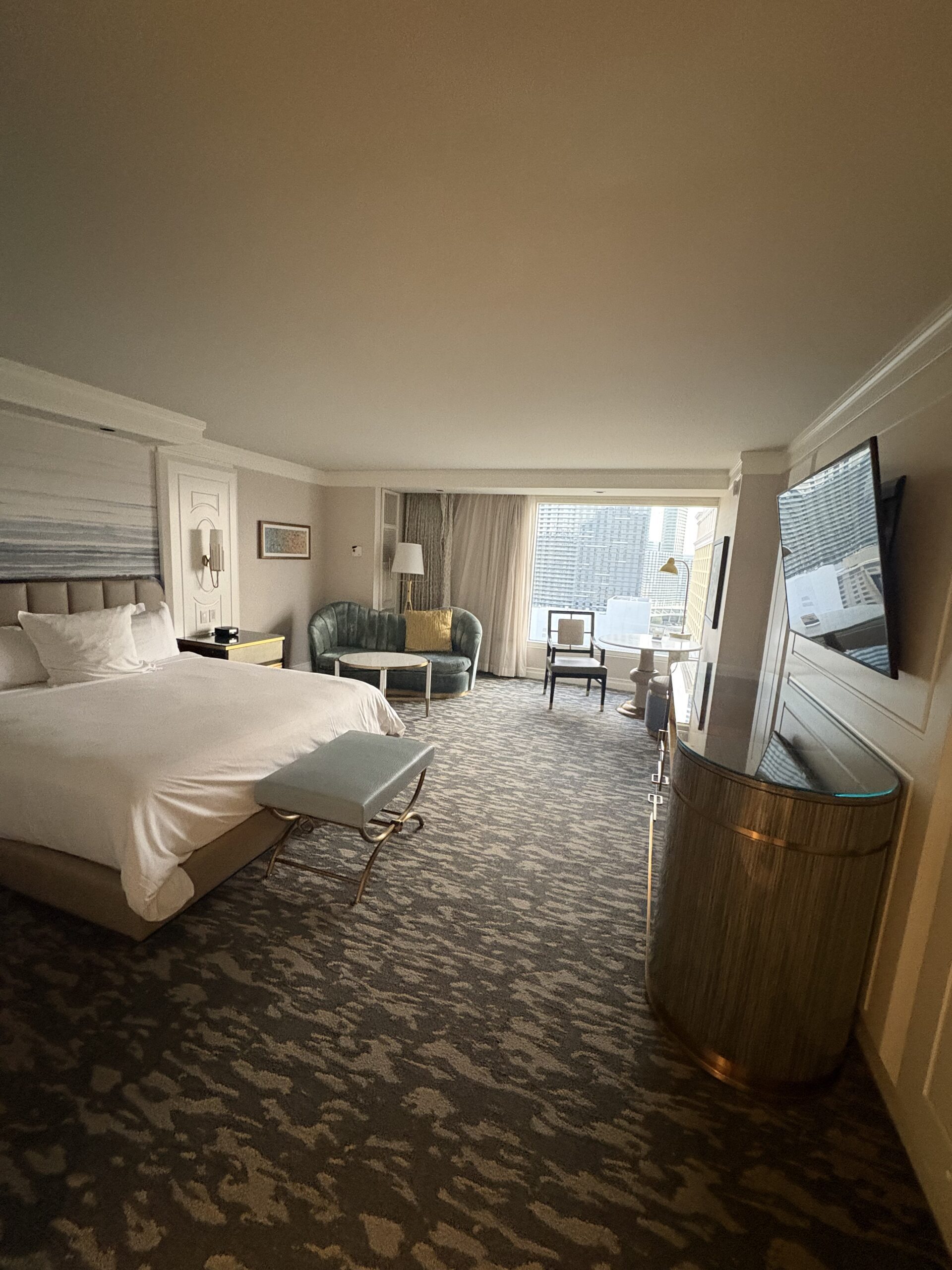 Bellagio guest room looking from the bed toward the seating area and pool view