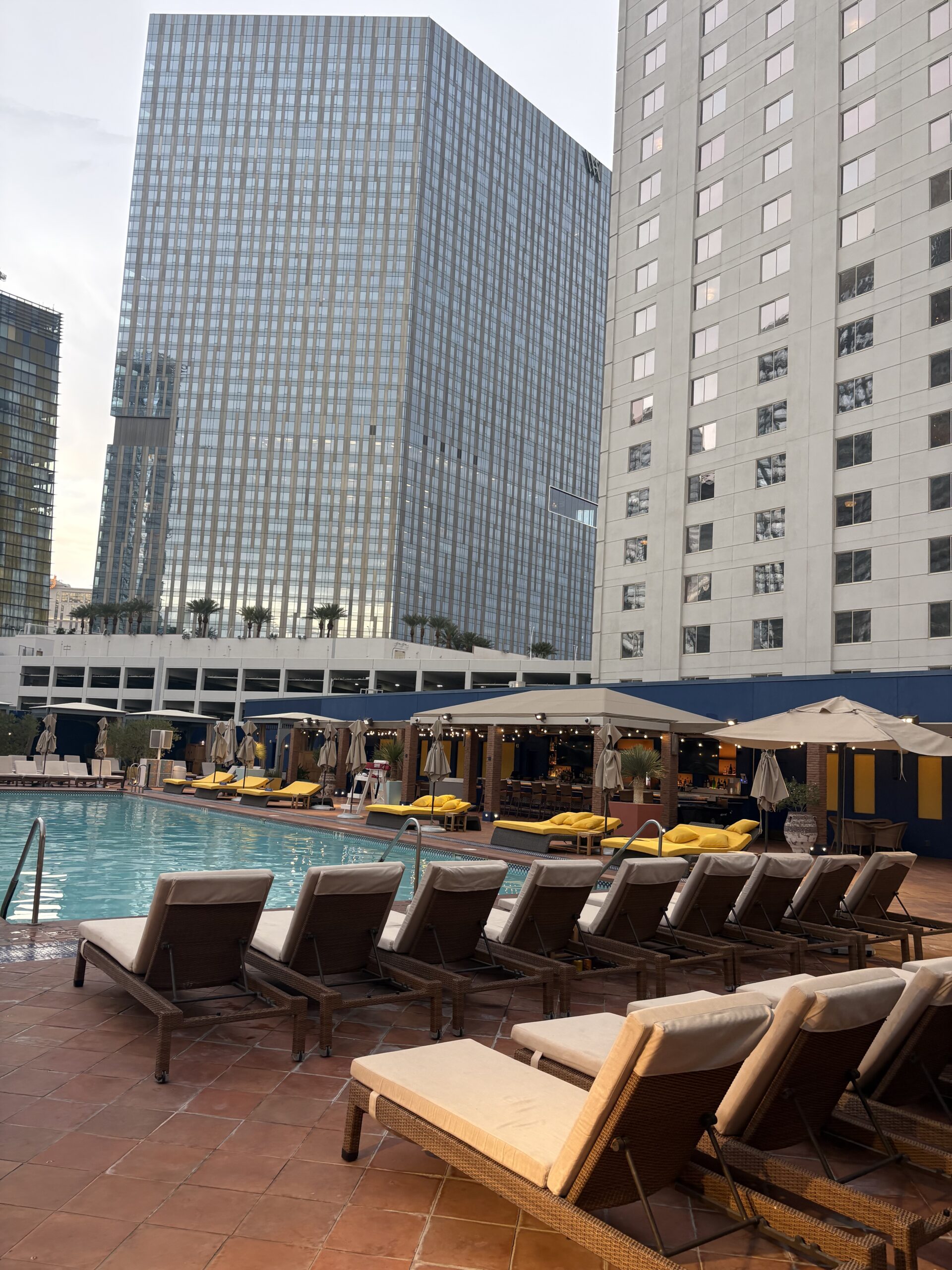 Terrace Pool at Park MGM with lounge chairs and Las Vegas skyline