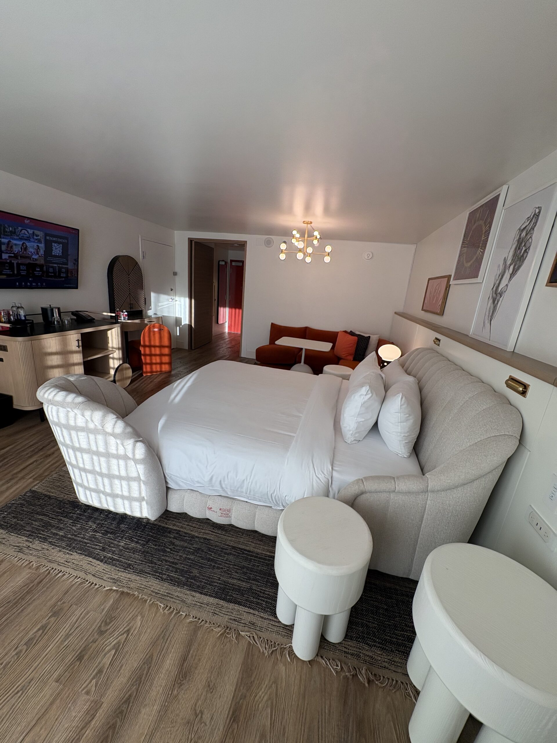 Shell-shaped chaise lounge attached to the foot of the bed in a Virgin Hotels Las Vegas Chamber