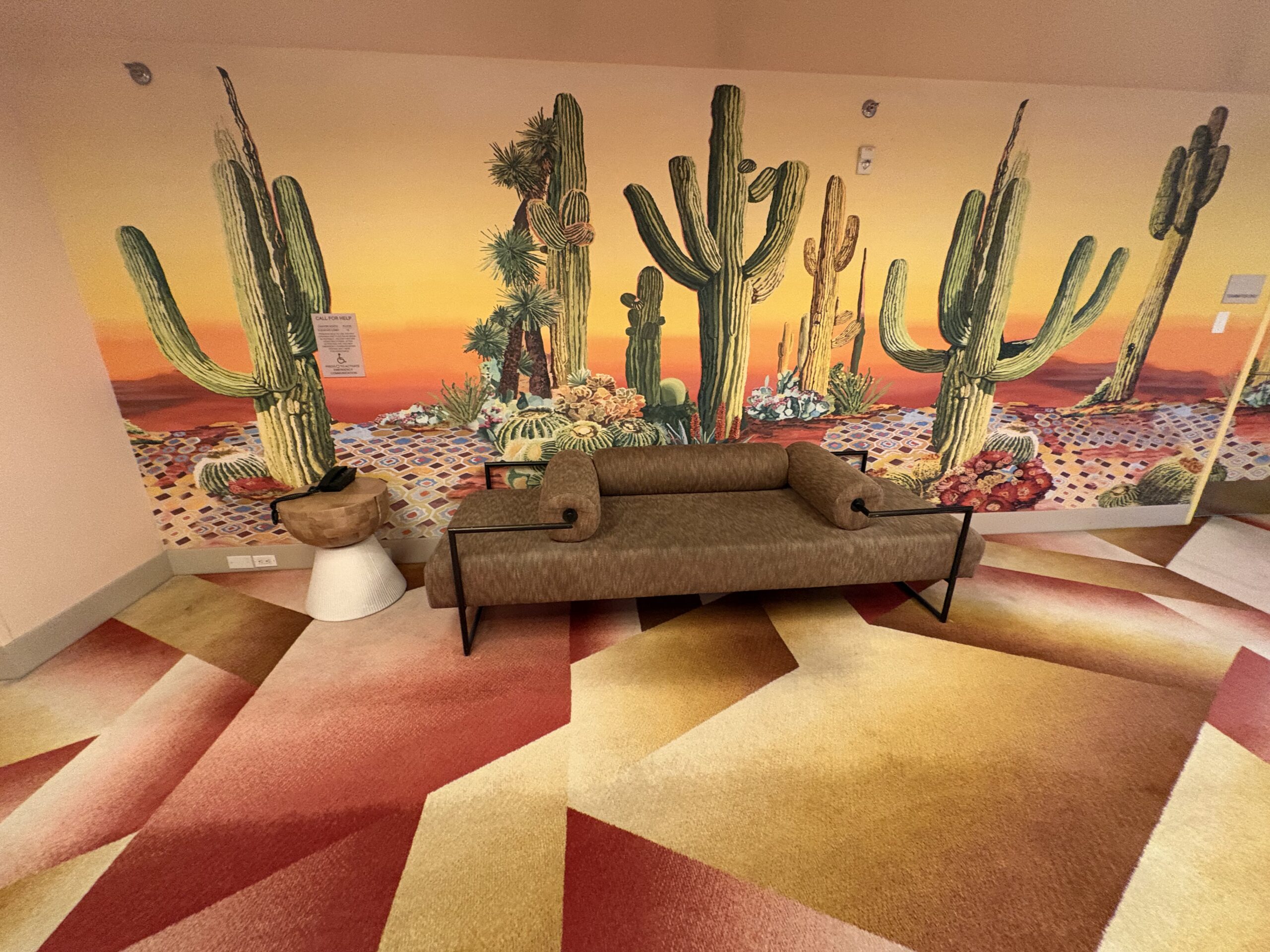 Saguaro sunset mural and lounge bench at the Virgin Hotels Las Vegas elevator landing