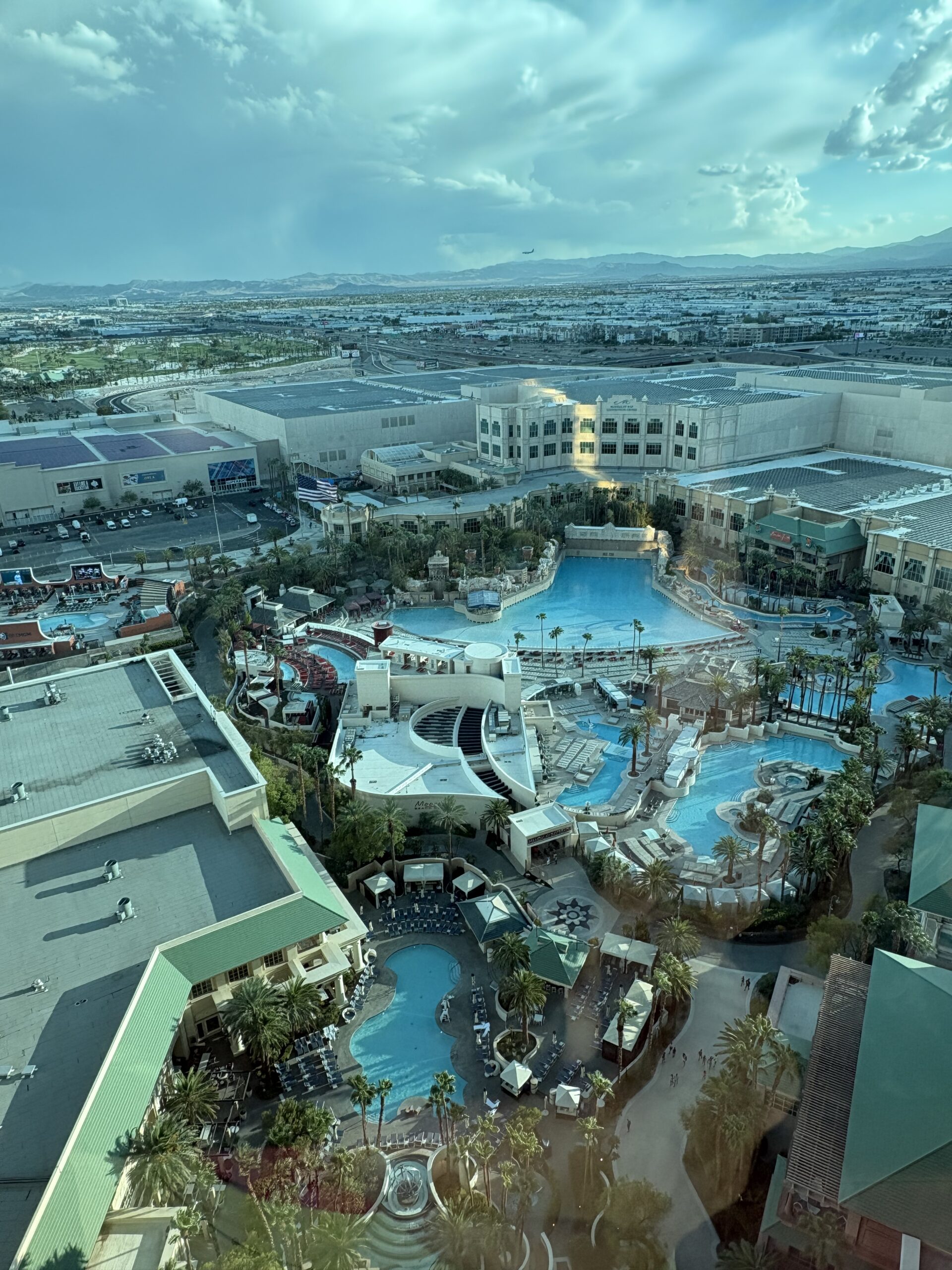 Aerial view of the Mandalay Bay pool complex in Las Vegas showing the wave pool, lazy river and surrounding pools from a guest room window