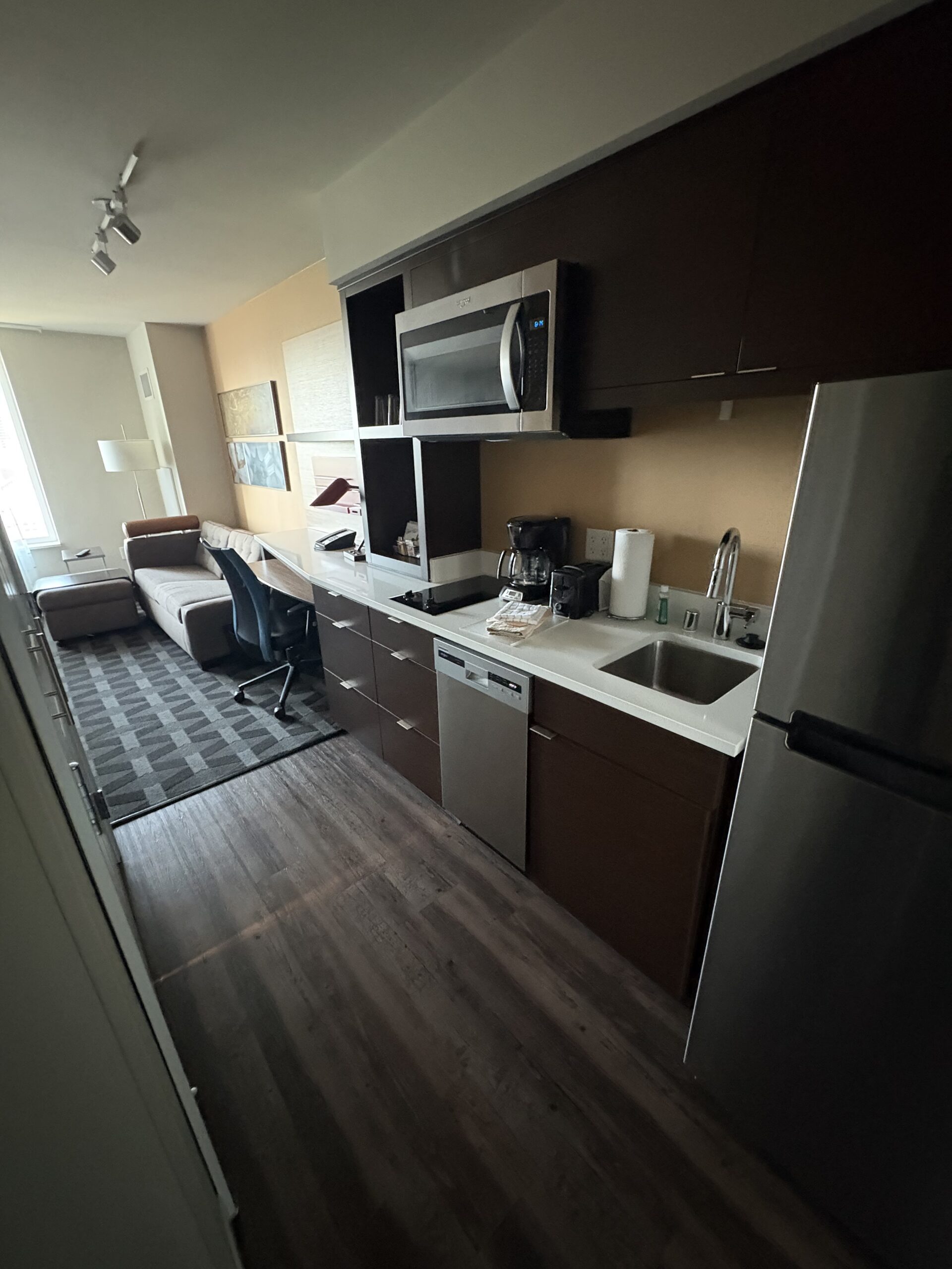 Full kitchen with stovetop, sink, dishwasher, and fridge at TownePlace Suites near Allegiant Stadium