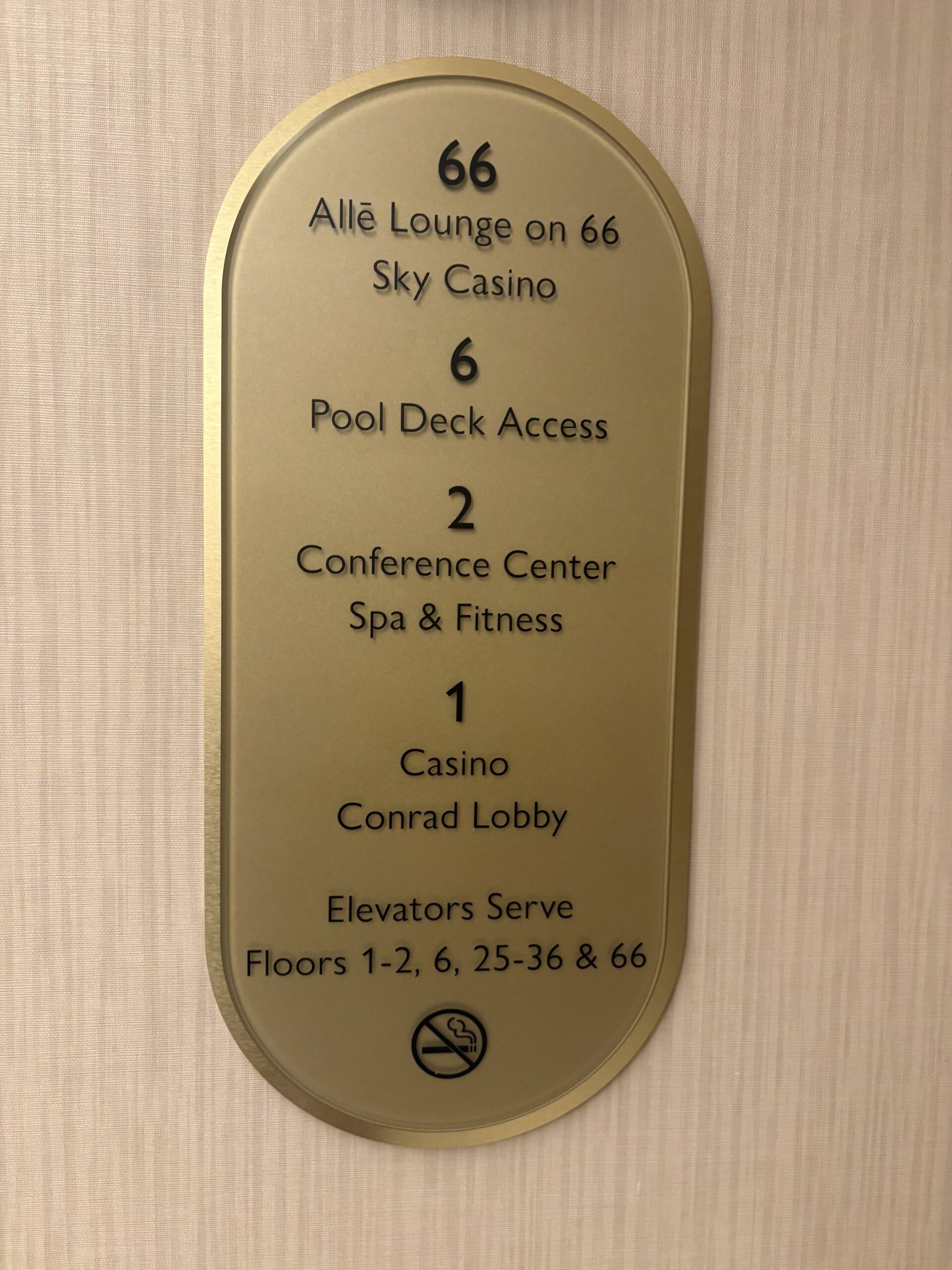 Brass elevator directory plaque listing the Allē Lounge, pool deck, spa, and casino floors at Conrad Las Vegas
