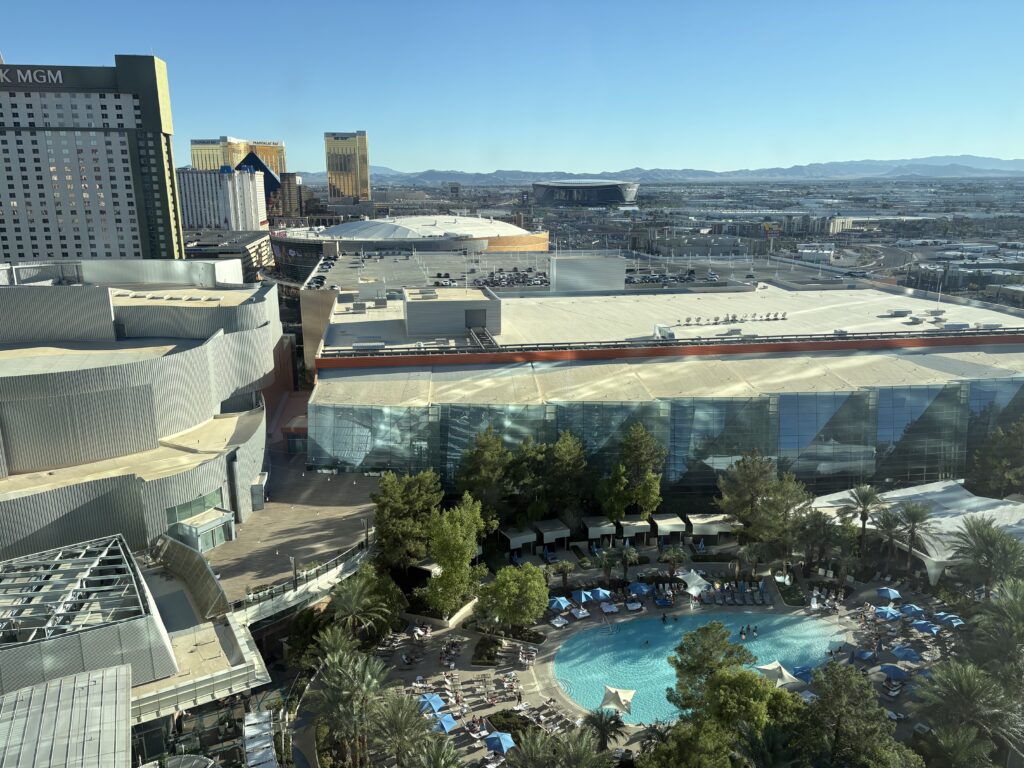 View from Aria's 20th floor over the pool toward Mandalay Bay and Allegiant Stadium