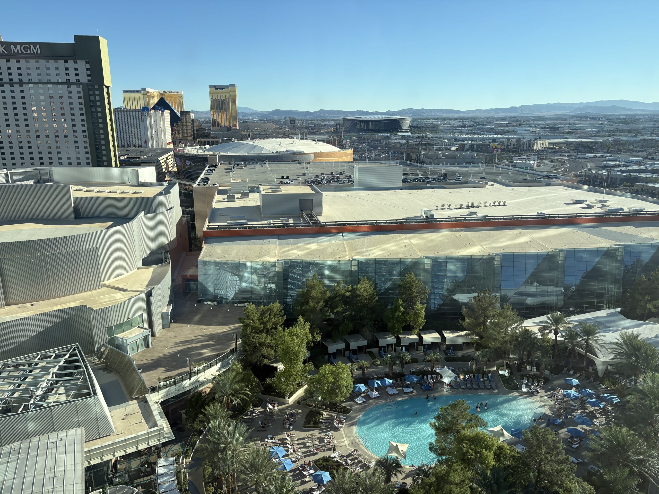 View from Aria's 20th floor over the pool toward Mandalay Bay and Allegiant Stadium