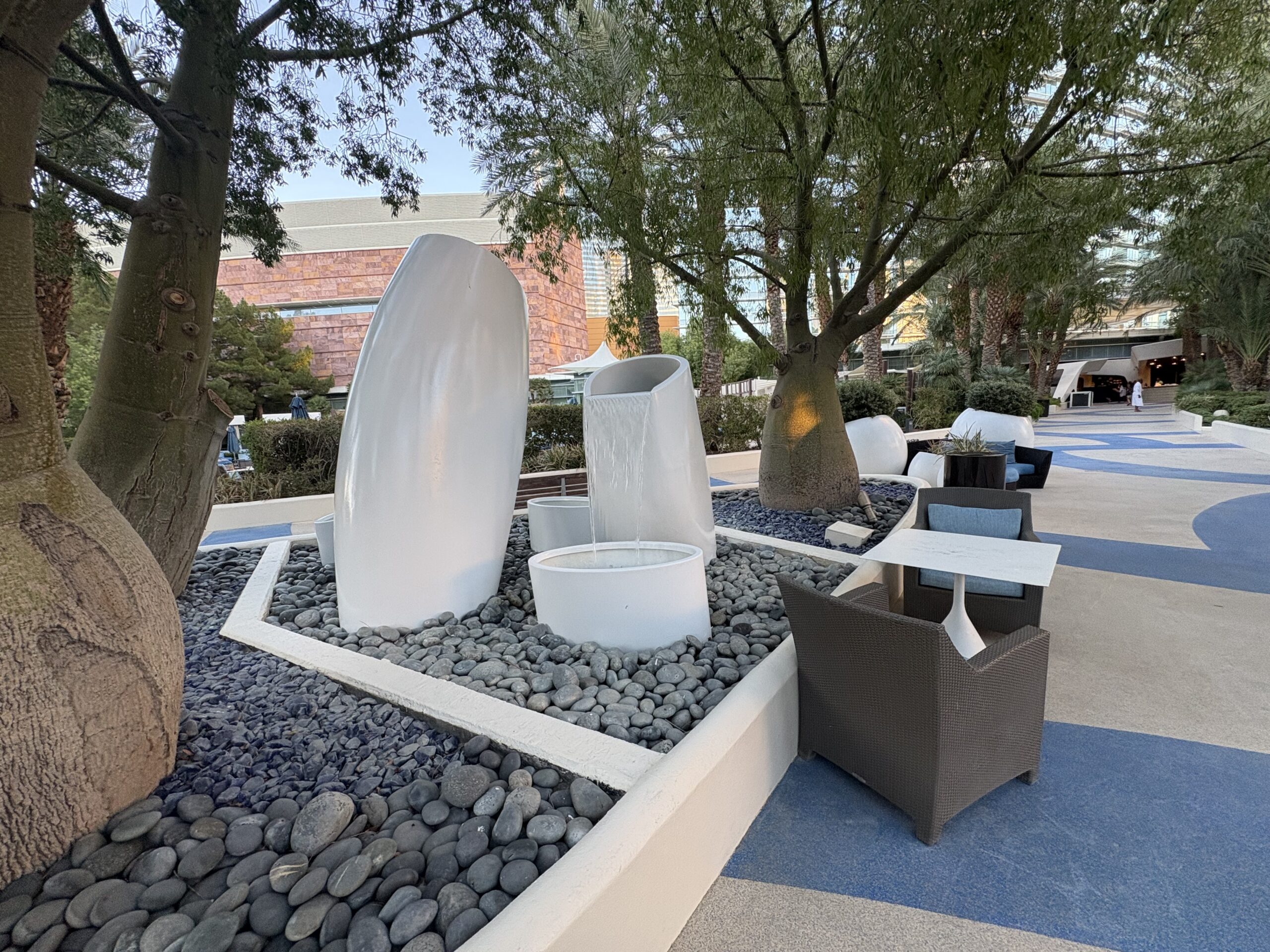 White sculptural water fountains in the Aria pool garden