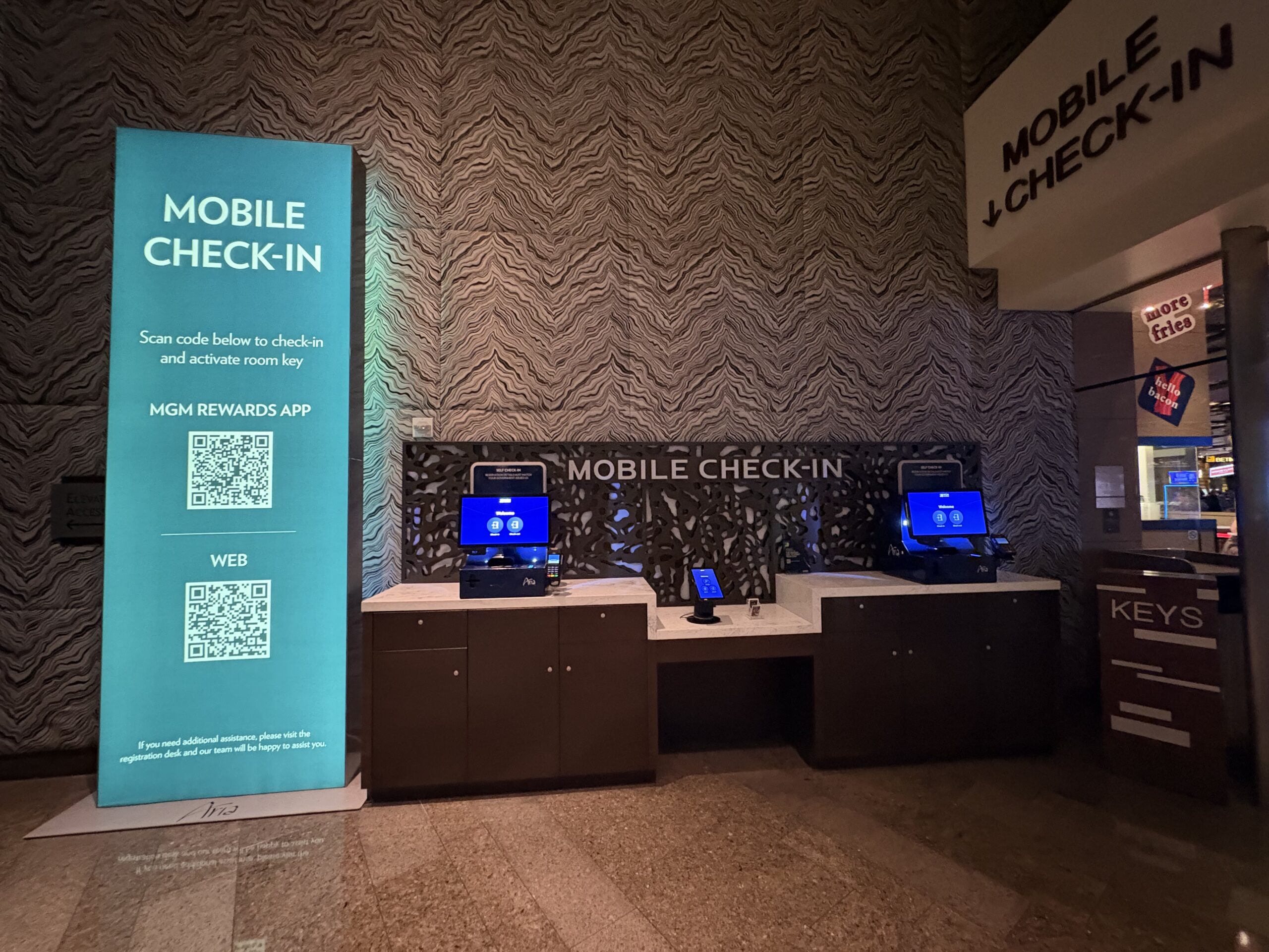 Mobile check-in area with self-service kiosks and key station at Aria
