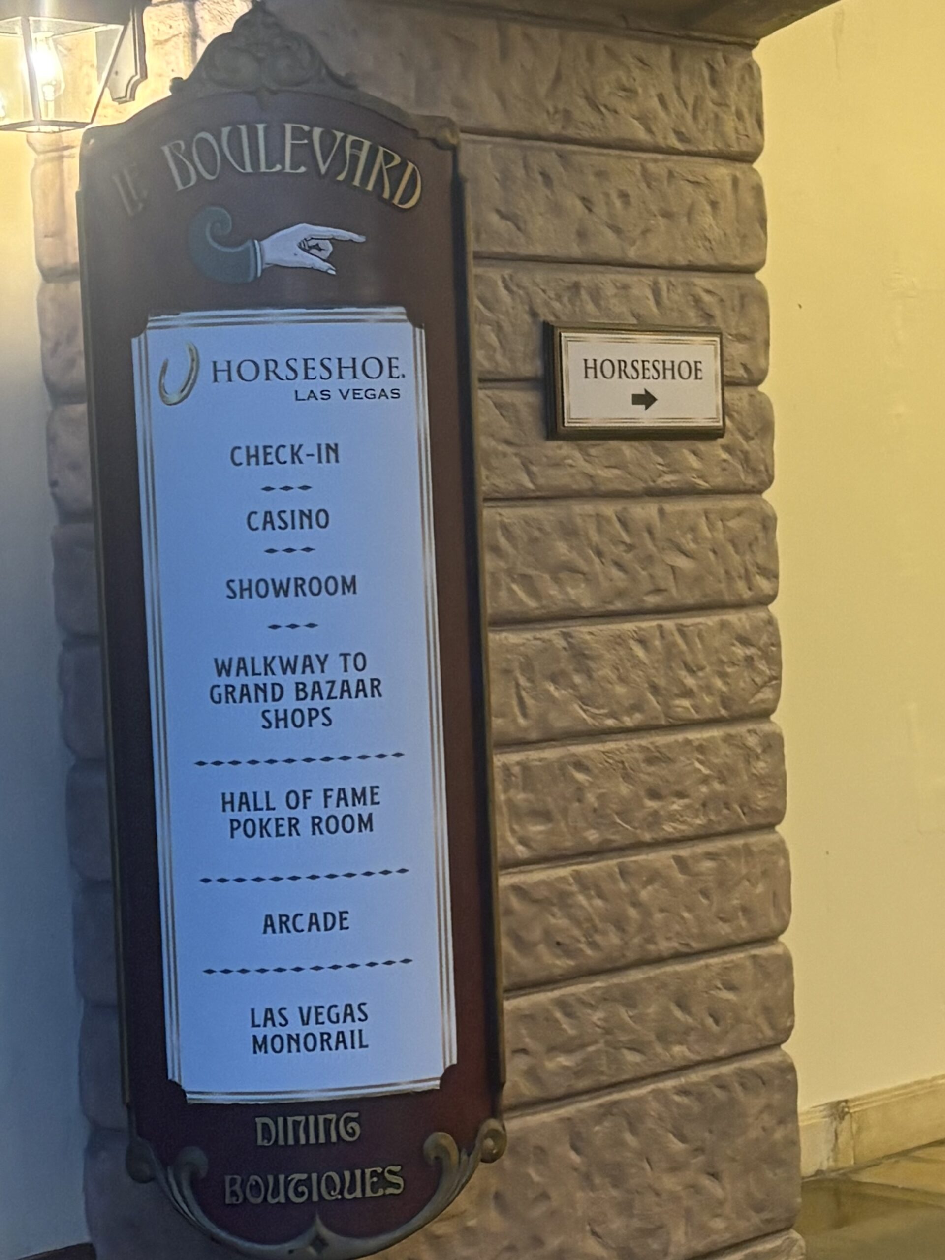 Le Boulevard sign at Paris Las Vegas pointing toward Horseshoe, listing check-in, casino and the Las Vegas Monorail