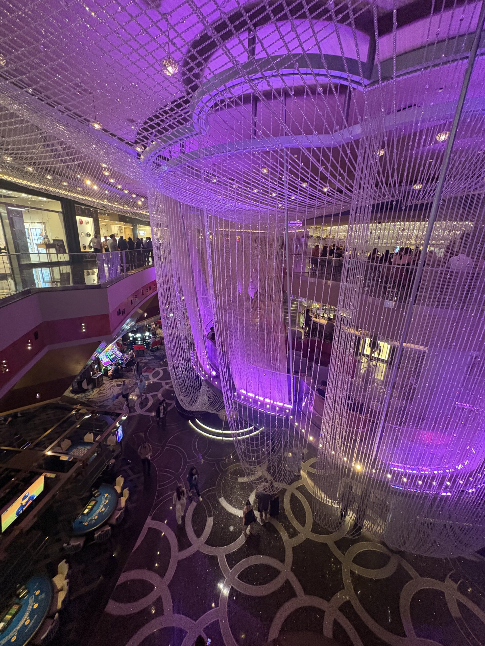 The Chandelier Bar at the Cosmopolitan Las Vegas, with crystal strands wrapping three levels in purple light